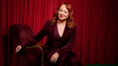 mandy mcelhinney dressed in red against a red backdrop for a photoshoot