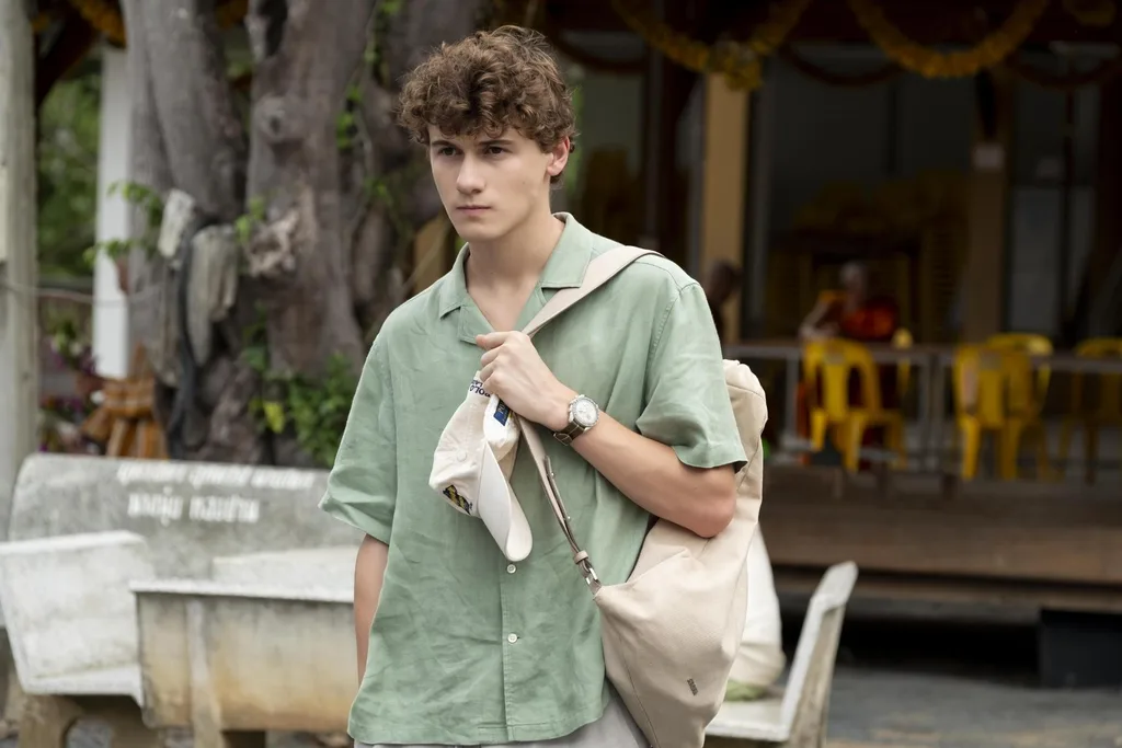 sam nivola with brown curly hair