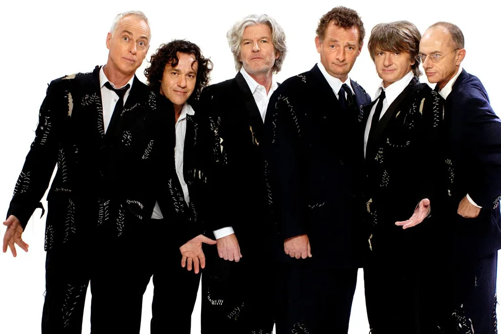 split enz members in black suits against a white background