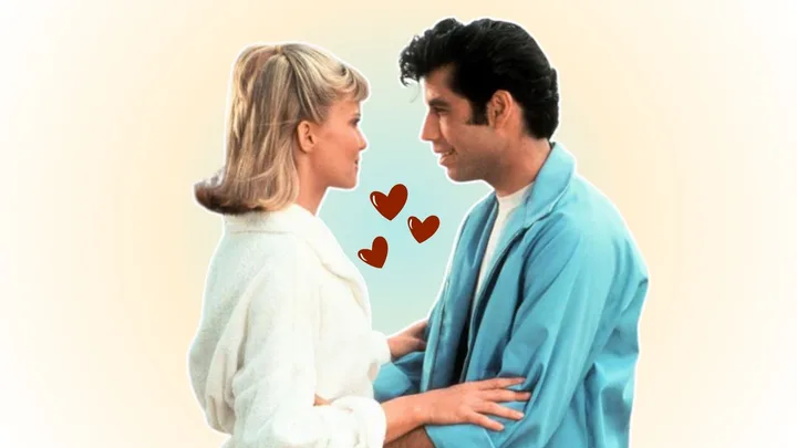 Grease: A blonde woman and a man with dark hair embracing each other while looking into each other's eyes, a scene from Grease the movie