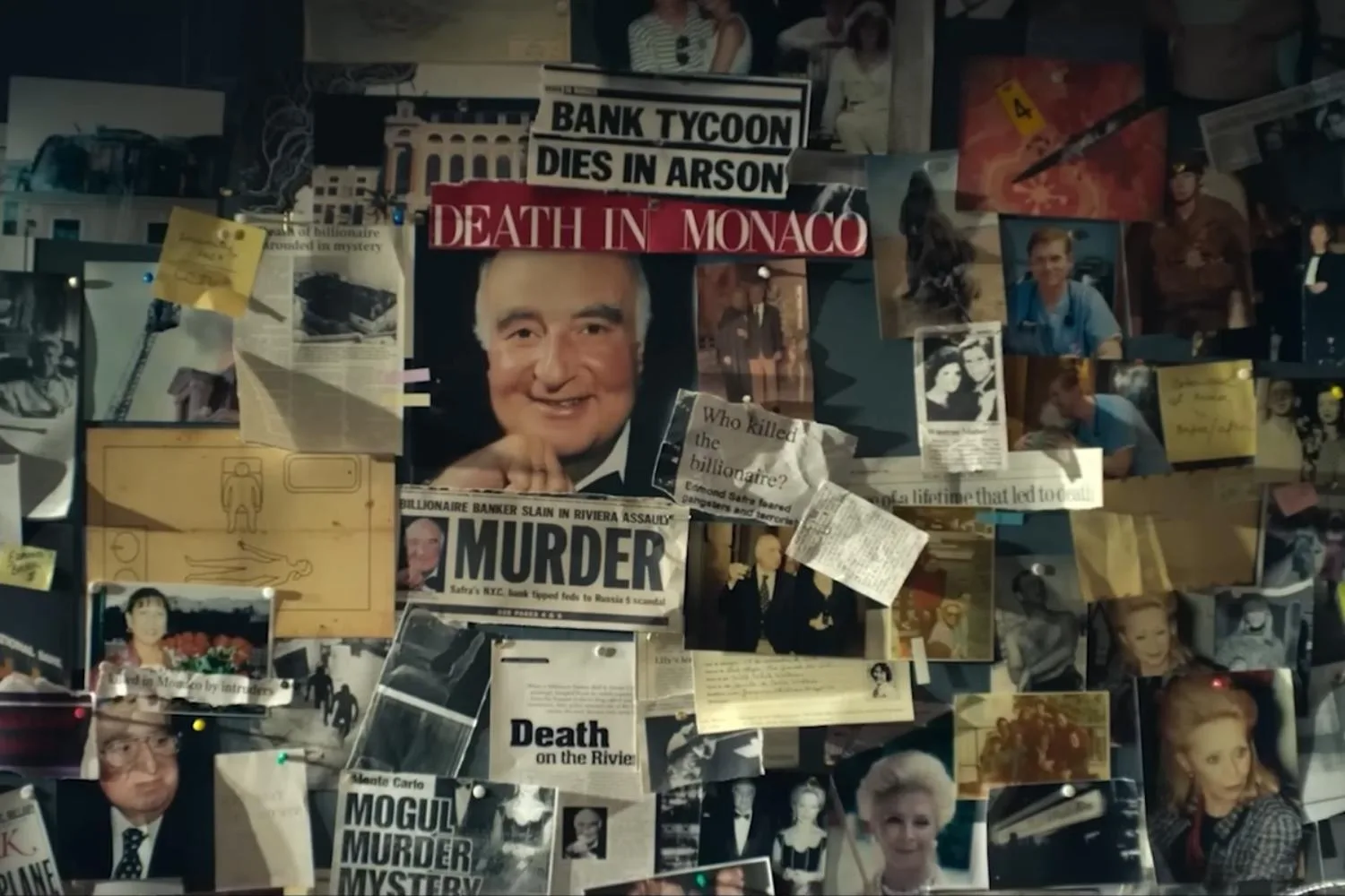 still from the murder in monaco trailer of a murder wall with newspaper cuttings