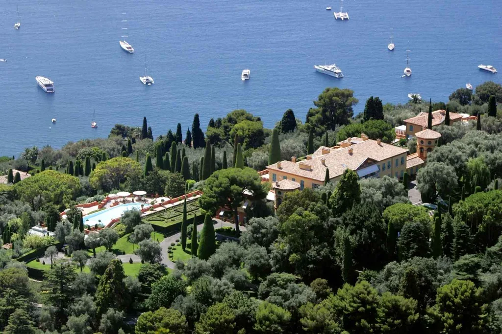 an above shot of monaco with boats on the water and large houses amongst trees