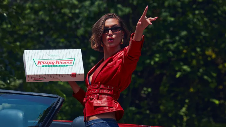 Hailey Bieber holds Krispy Kreme doughnuts
