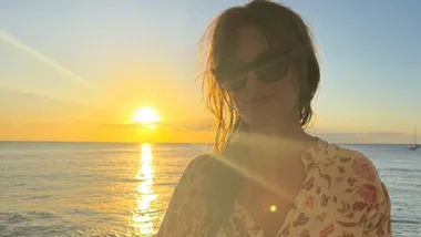 Isla Fisher spotted on romantic holiday with mystery man