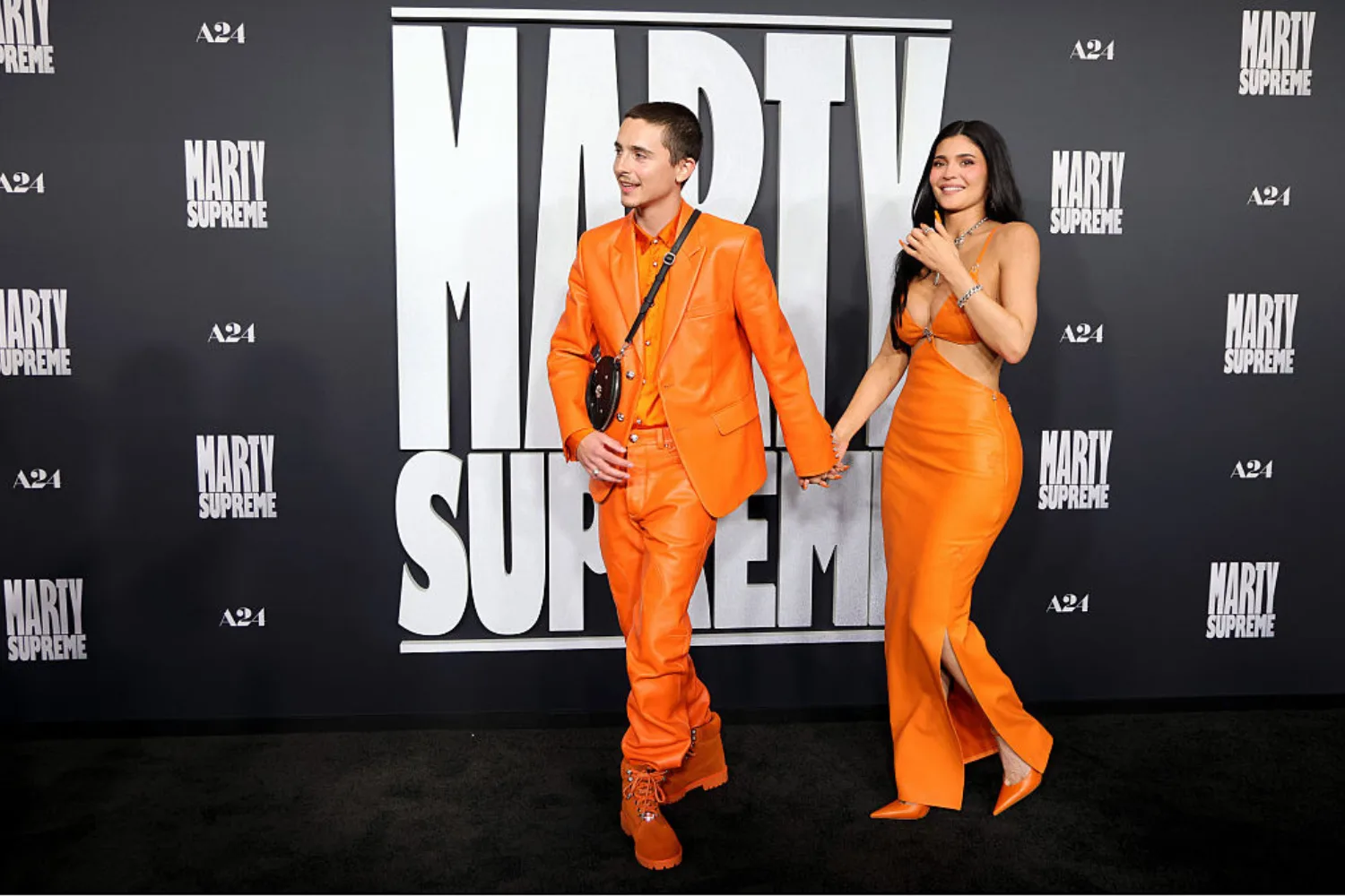 Timoth&eacute;e Chalamet and Kylie Jenner wearing matching orange at the Marty Supreme premiere. 