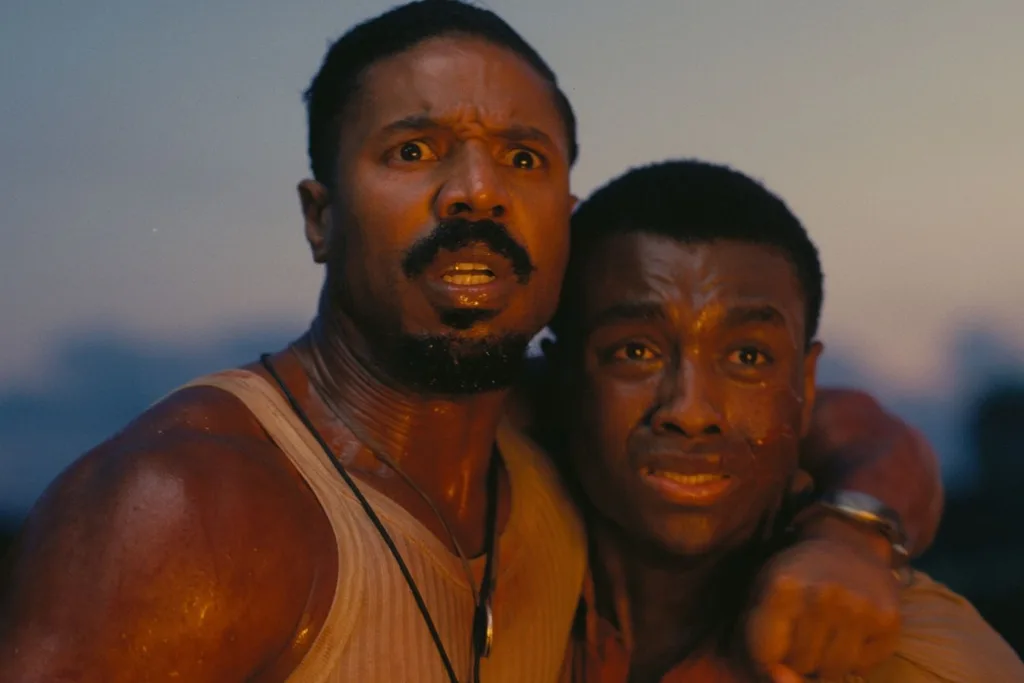 two men with arms around each other looking concerned at something off camera