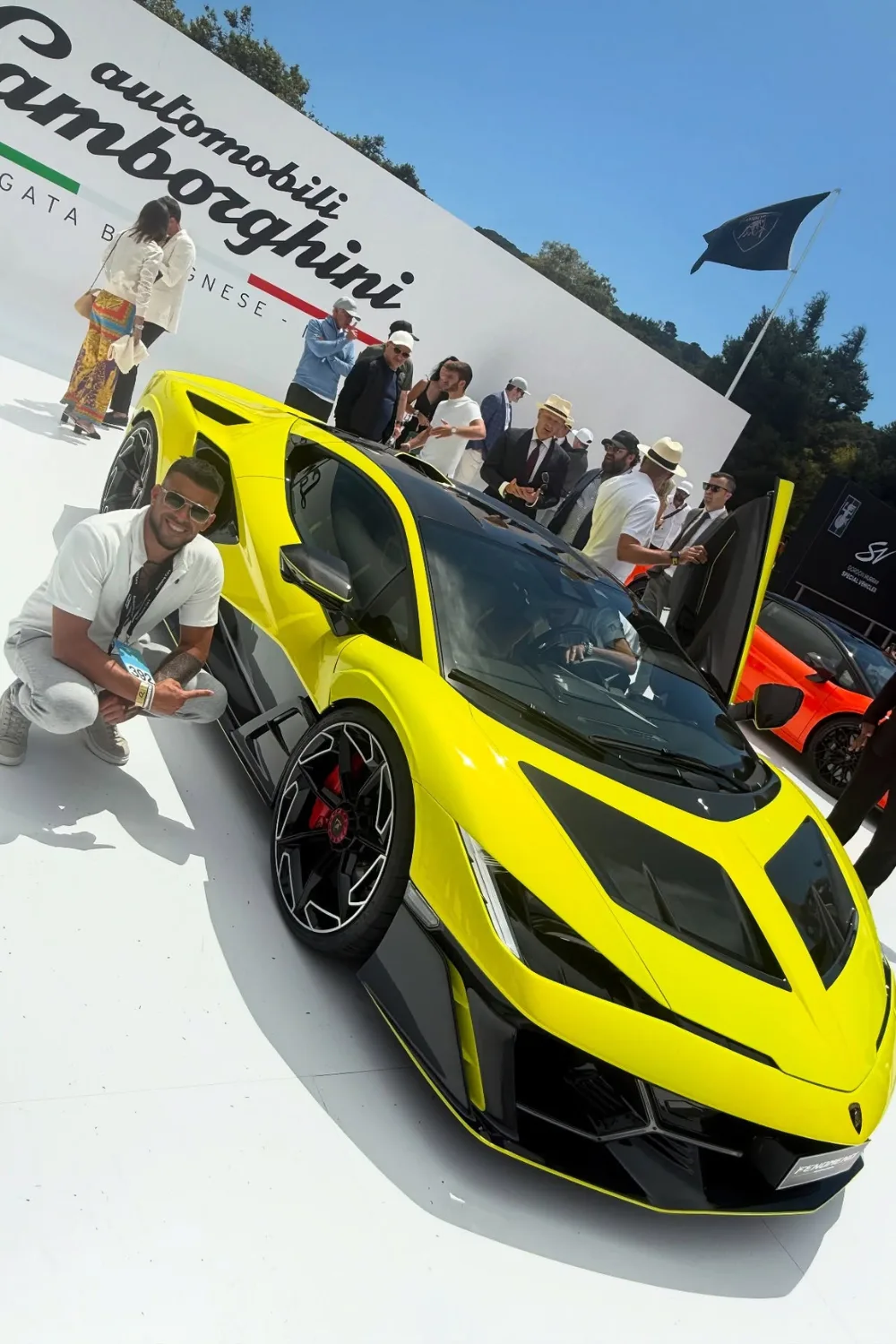 Adrian Portelli in front of a yellow Lamborghini.