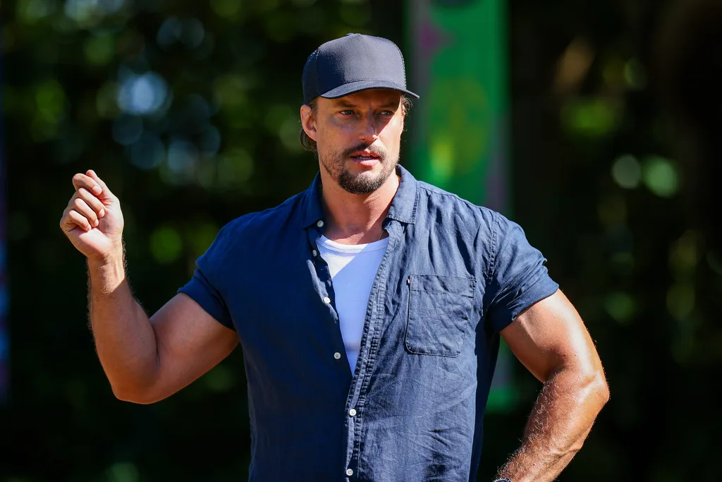 david genat in a cap and shirt talking to contestants for survivor australia 2026