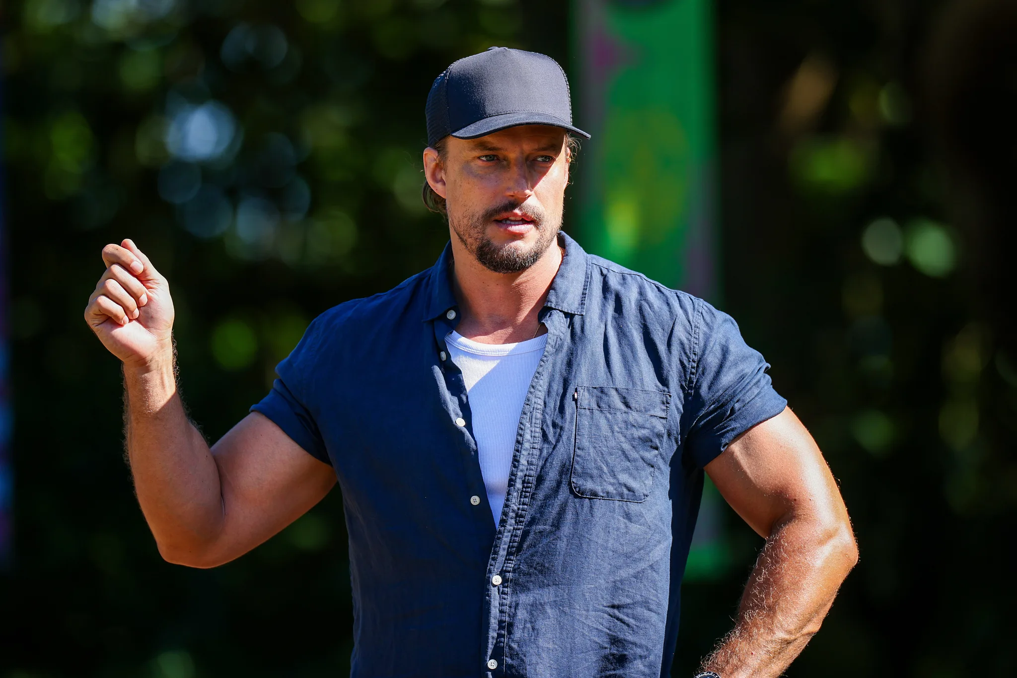 david genat in a cap and shirt talking to contestants for survivor australia 2026