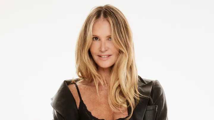 Elle MacPherson posing for Bonds in matching black underwear set and jacket.