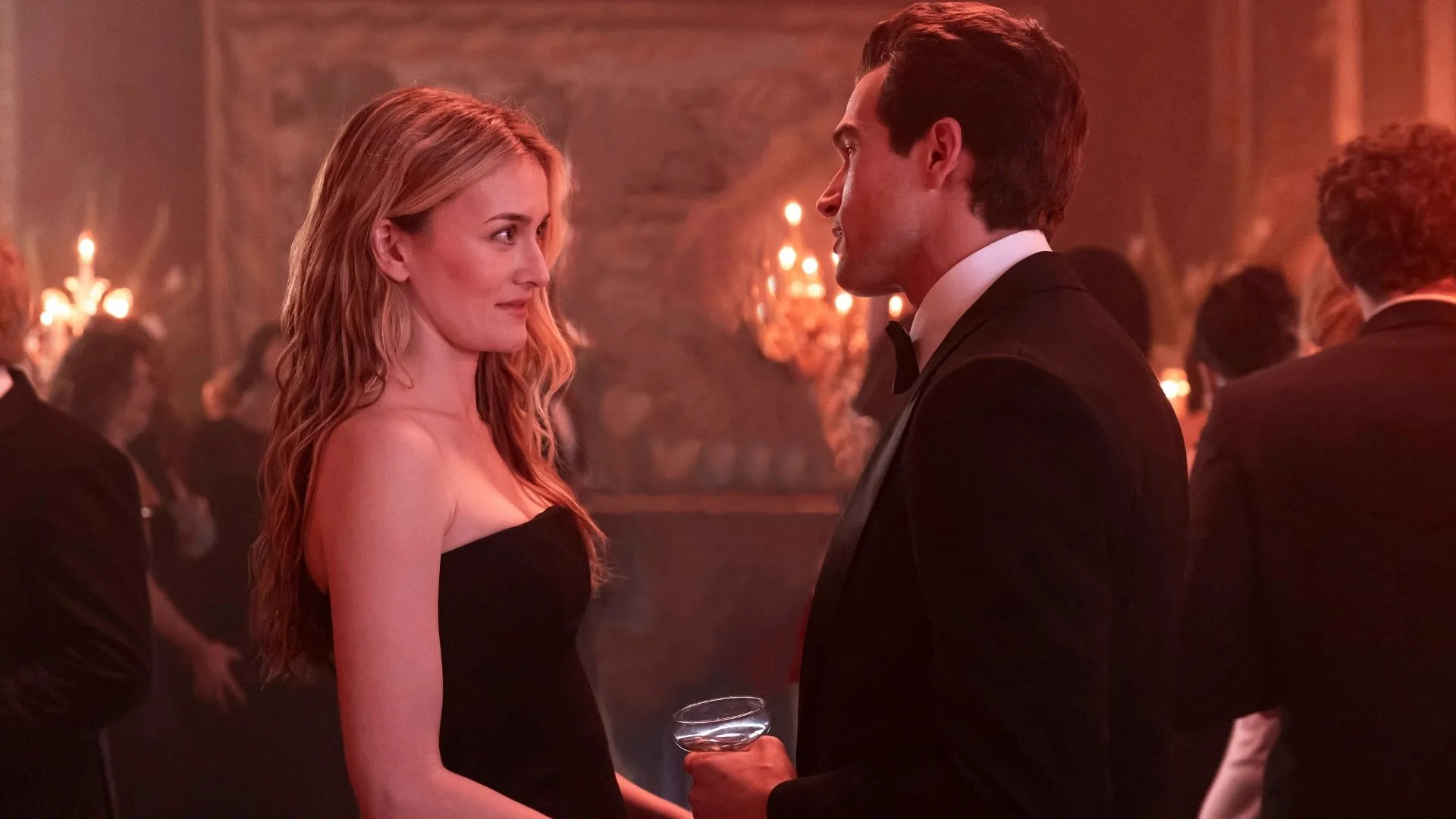 sarah pidgeon and paul anthony kelly in costume for love story in a candlelit room looking lovingly at each other