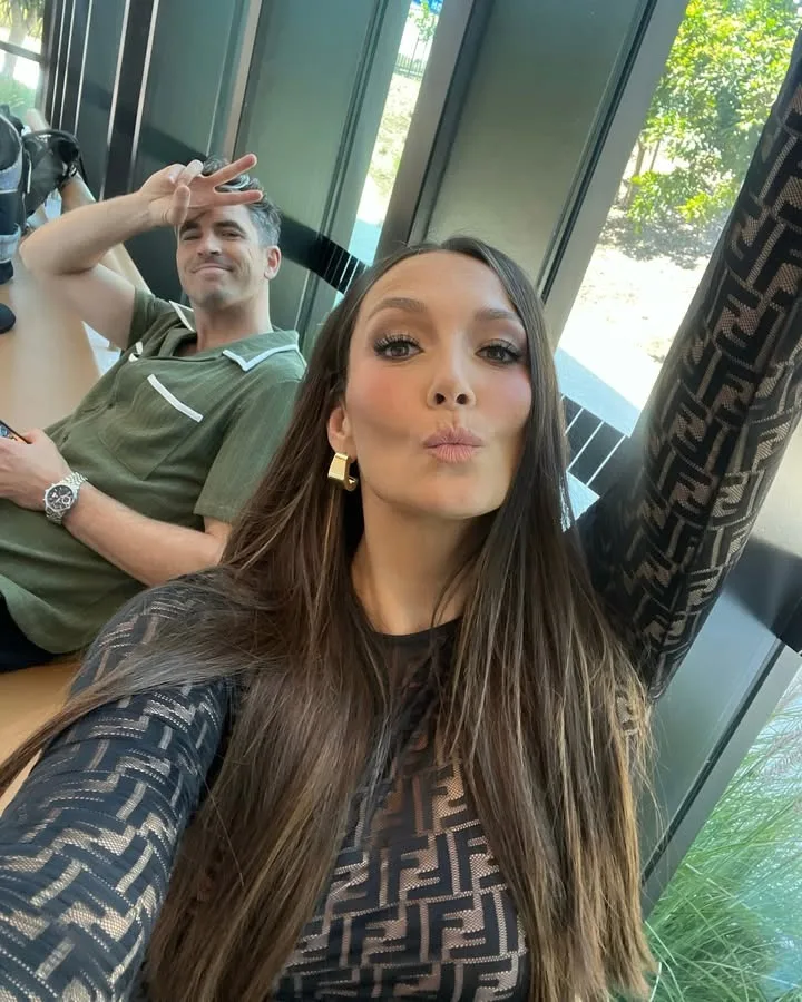 ricki-lee taking a selfie with scott tweedie on a couch