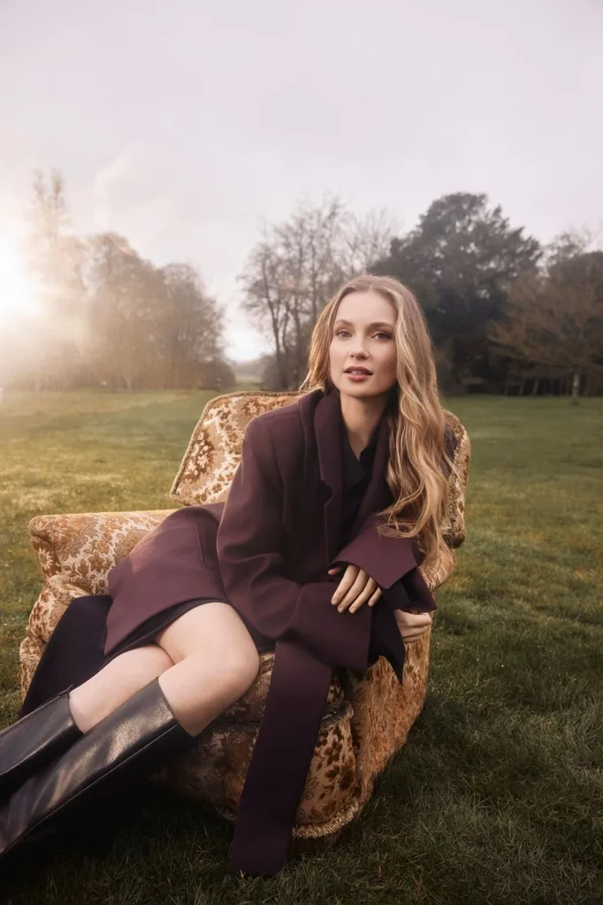 hannah dodd sitting in a chair on a lush grass lawn