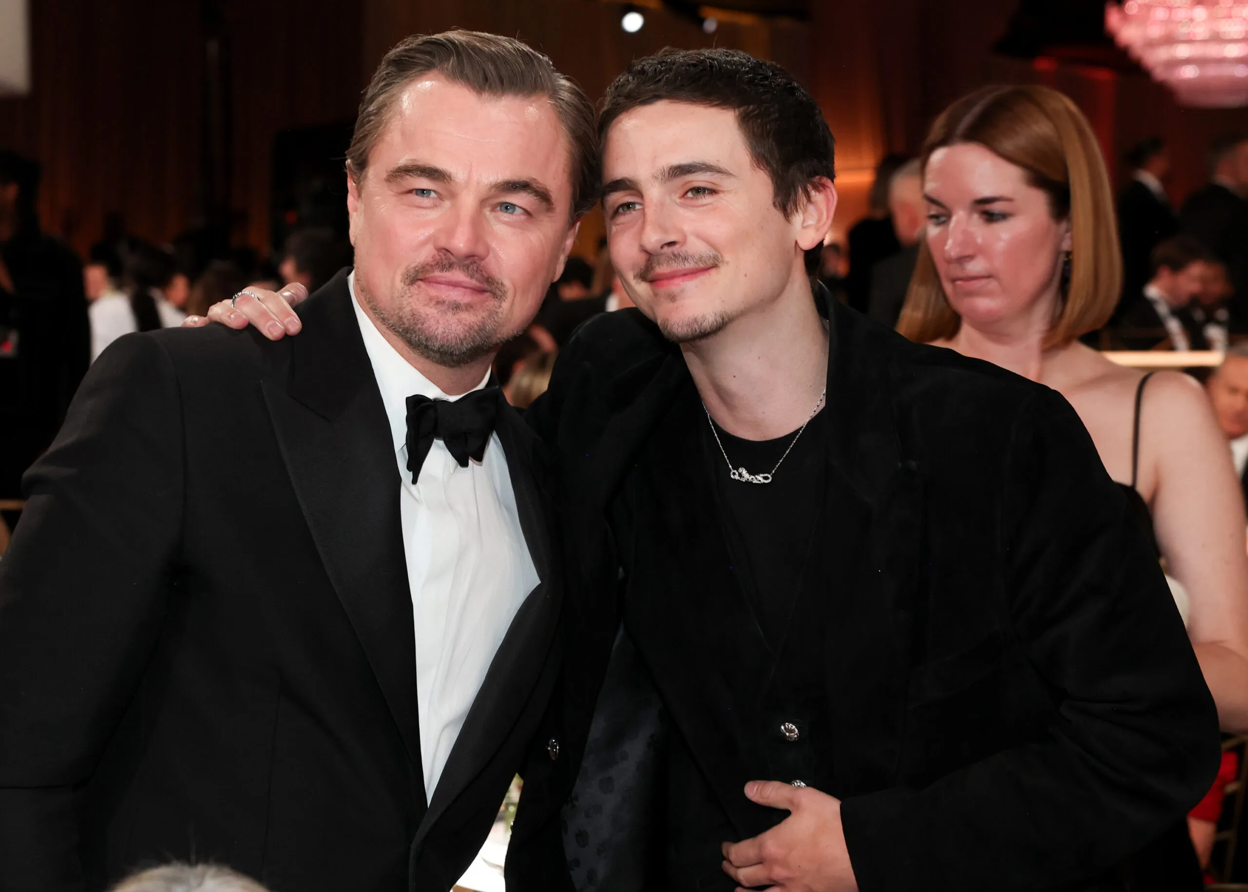 leonardo dicaprio and timothee chalamet in suits smiling for a photo together