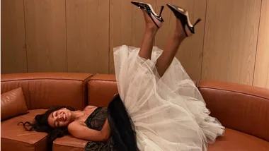 Olivia Dean lies on sofa