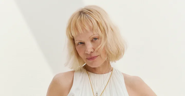 pamela anderson posing with a blonde bob and no makeup