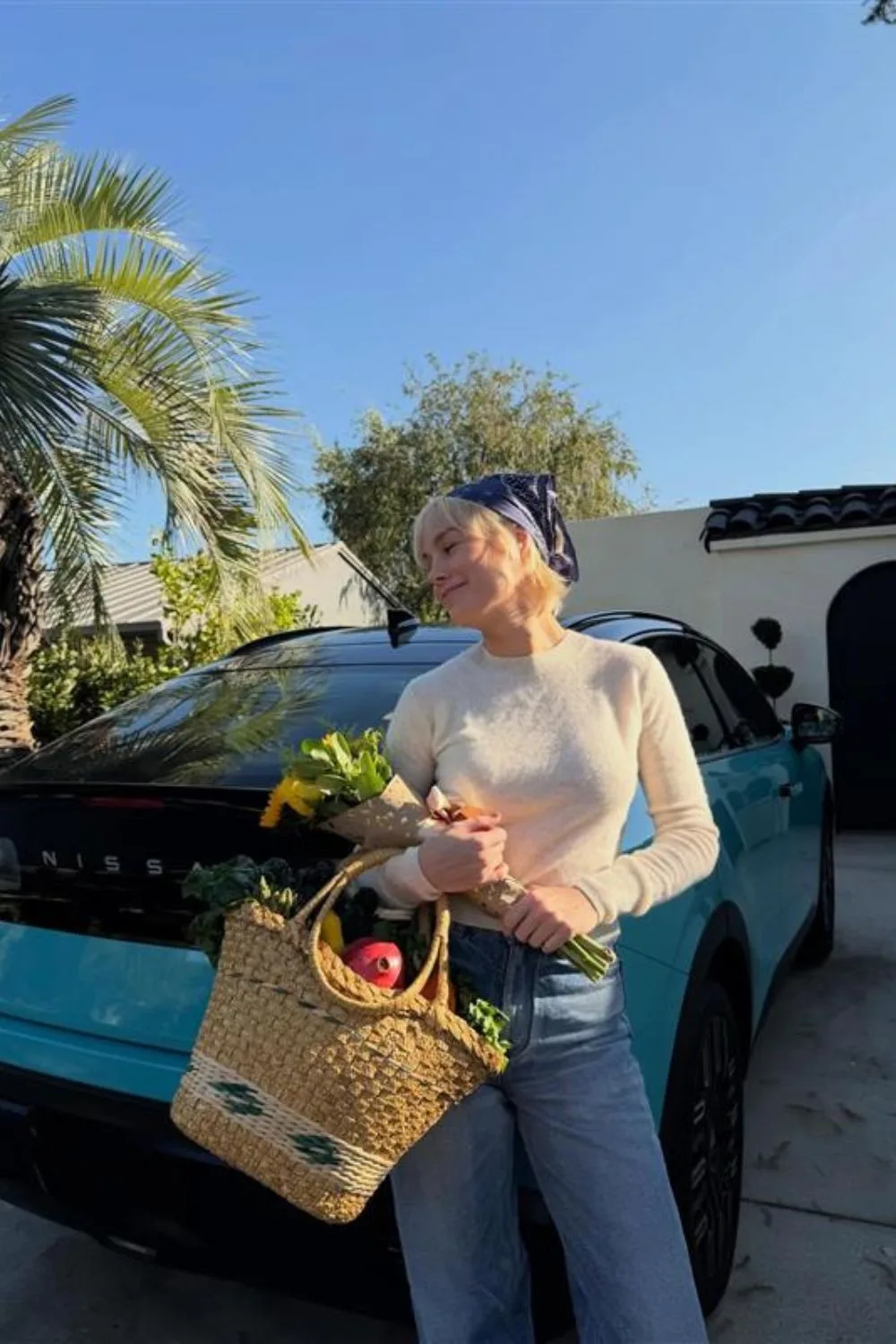 Brie Larson posing with fresh vegetables. 