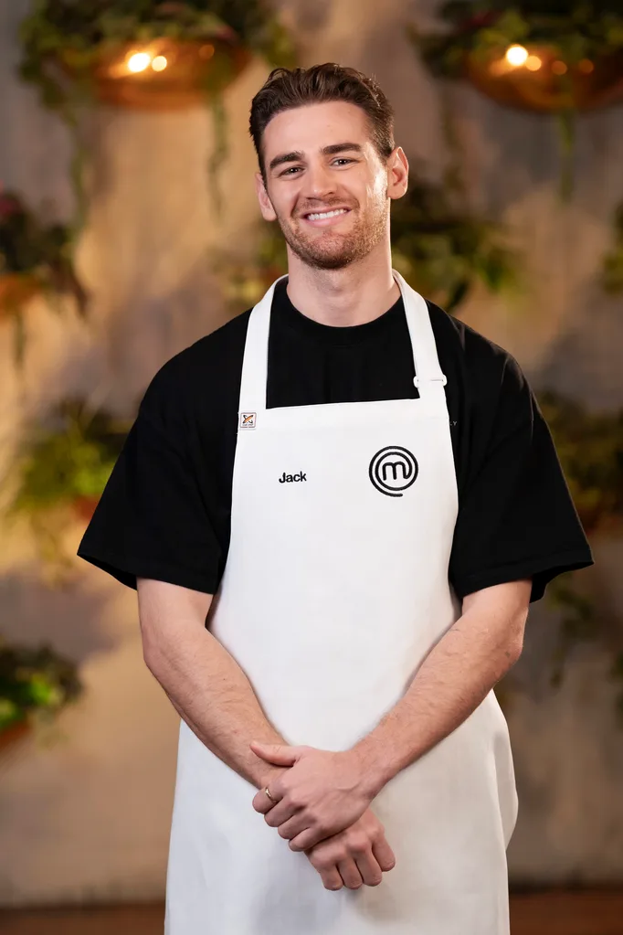 Jack stands in his white MasterChef apron.