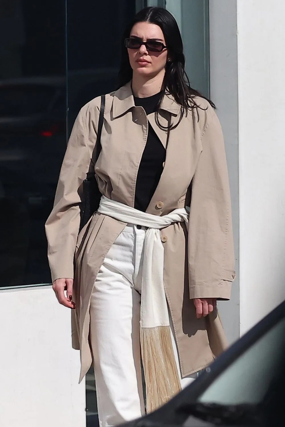 Kendall Jenner wearing a fringe scarf around her waist. 