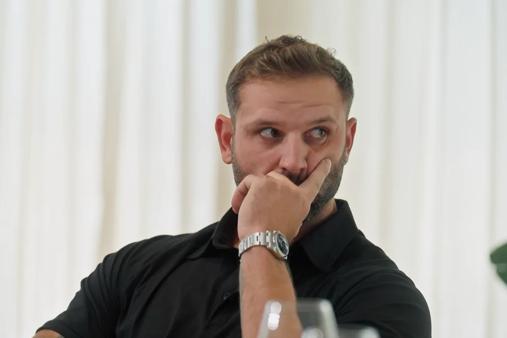 Scott sitting at a dinner party on MAFS.