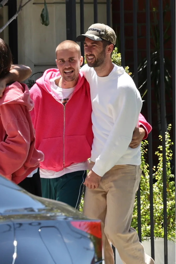 Justin Bieber hugging his male friends.