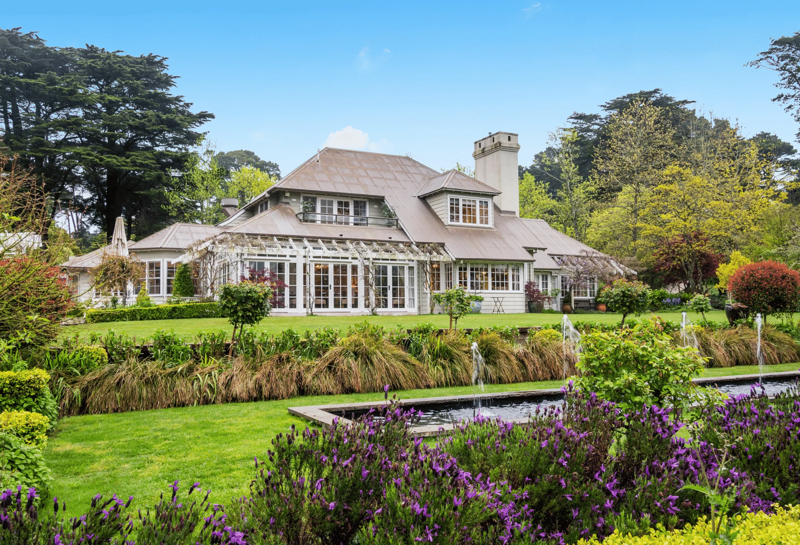A beautiful English style home sits amid stunning manicured gardens. 