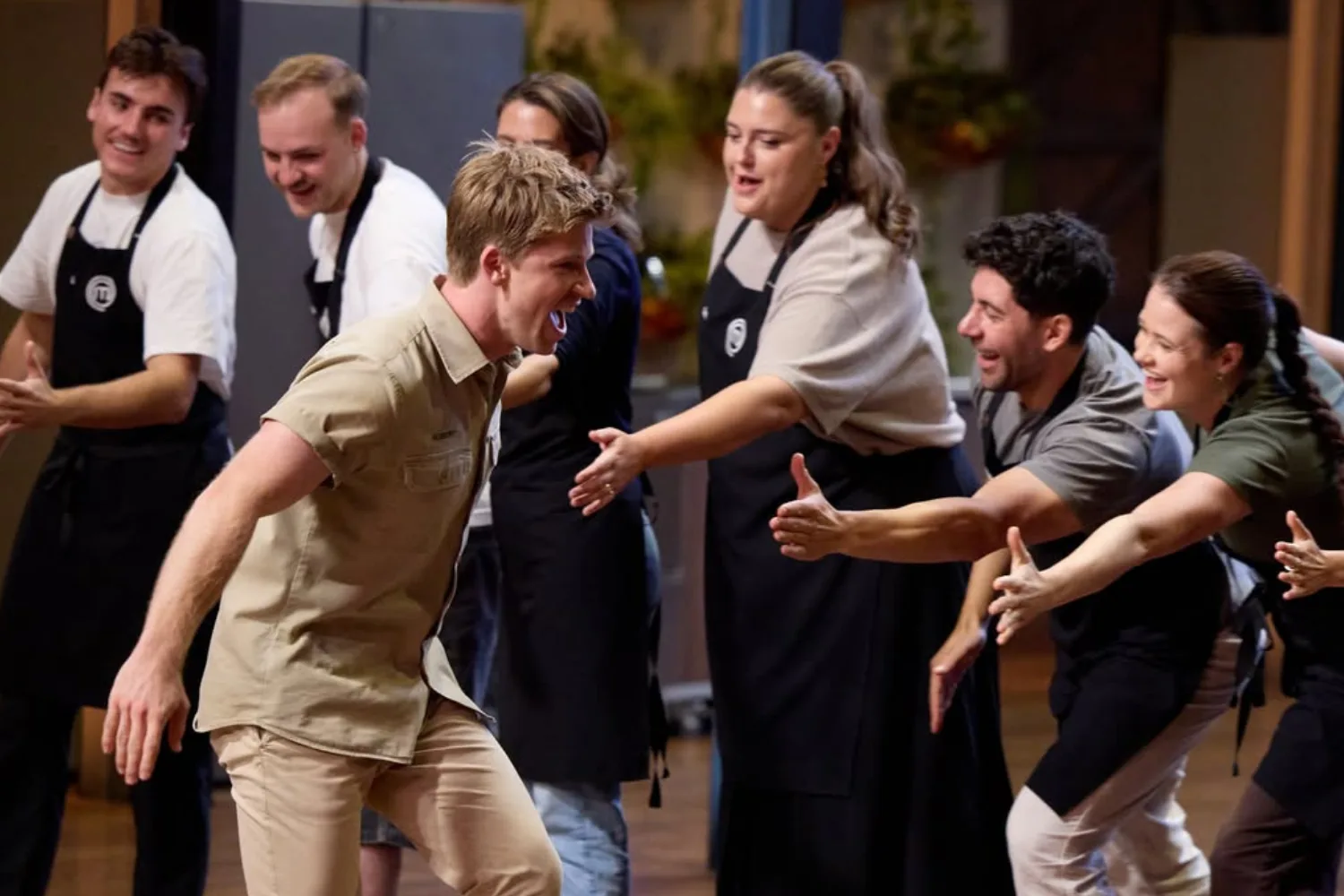Robert Irwin high-fiving all the MasterChef cooks. 