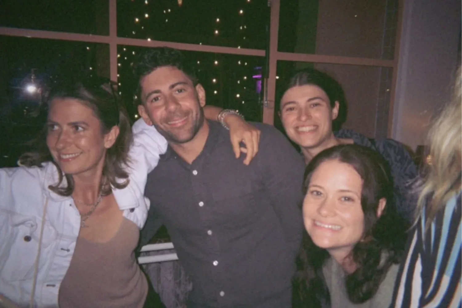 MasterChef contestants with Alyona draping her arm around Petro's shoulder. 