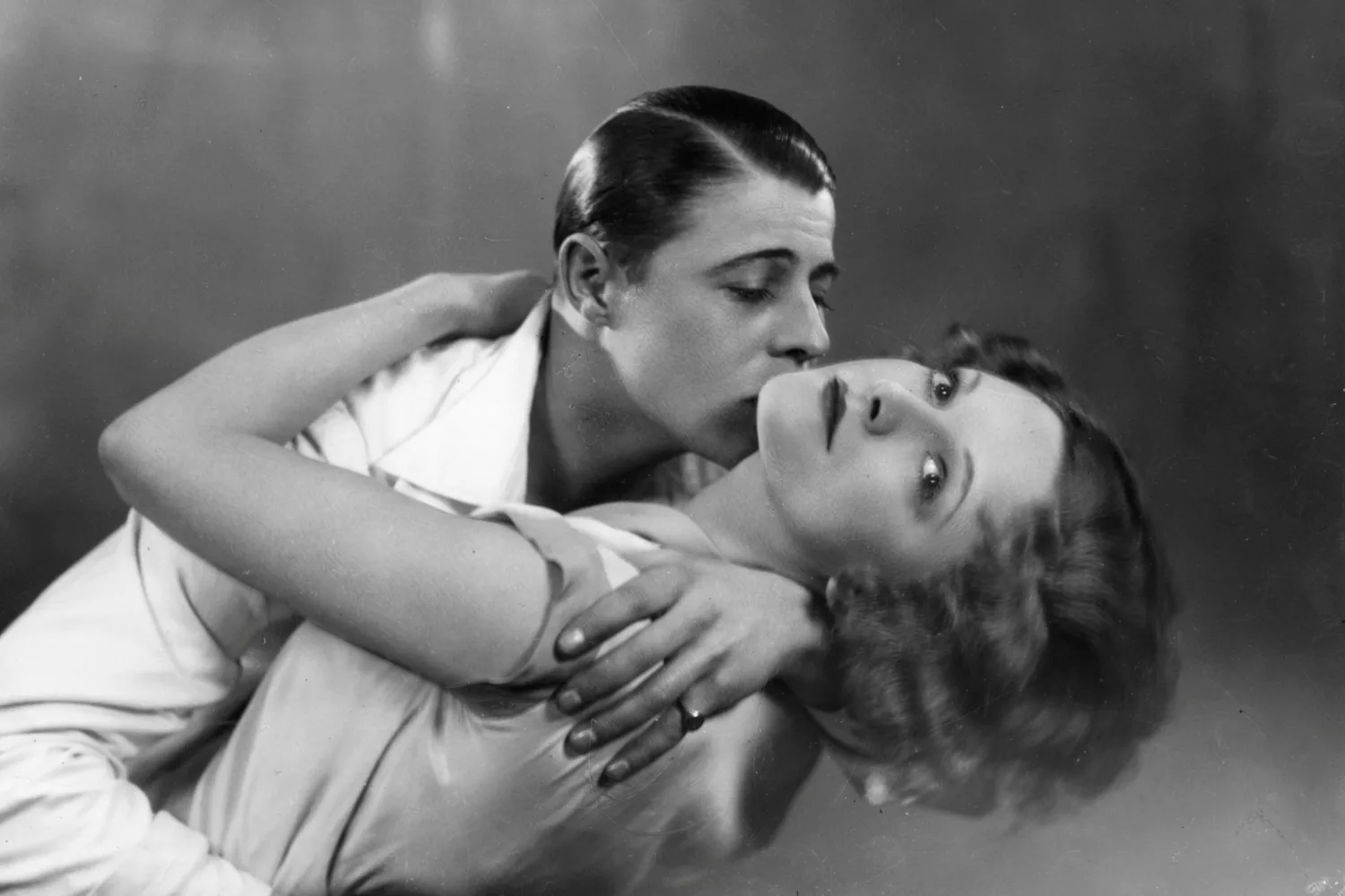  English actress Adrianne Allen in the arms of actor Patrick Suzande in a scene from the show 'Always Afternoon.' 