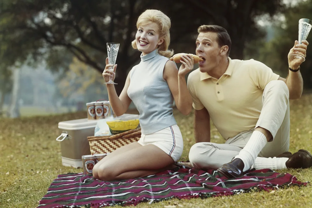 Young couple having drinks and food on vacation.