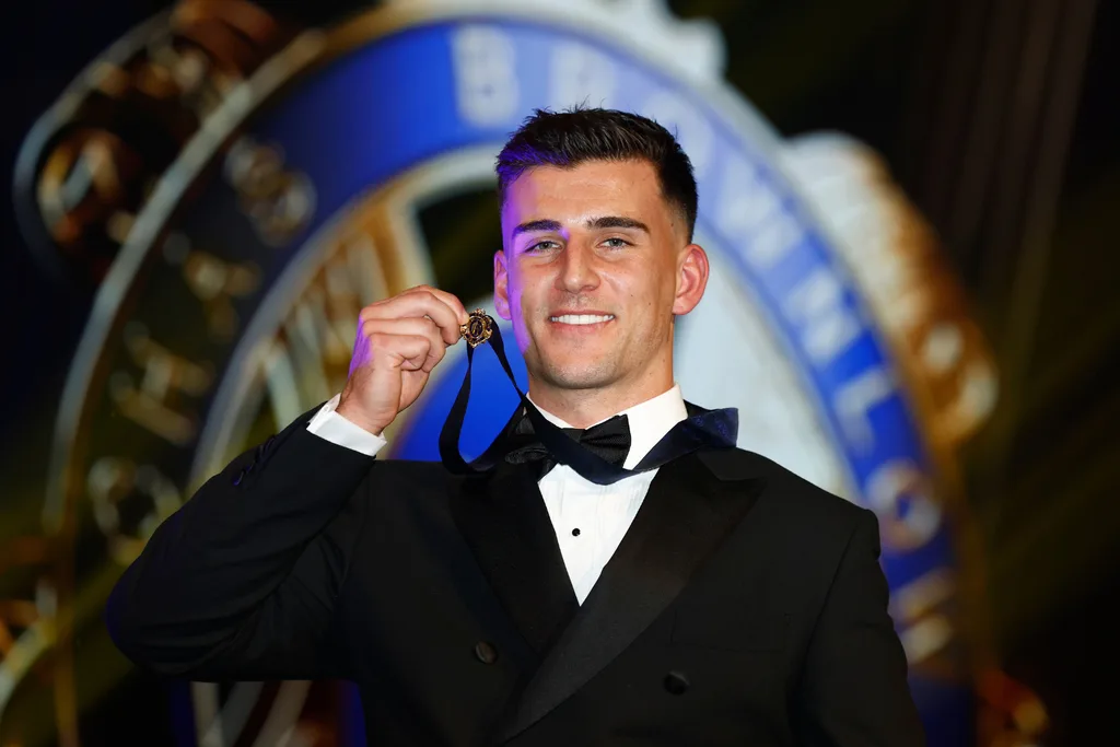 Nick Daicos holding the Brownlow Medal.