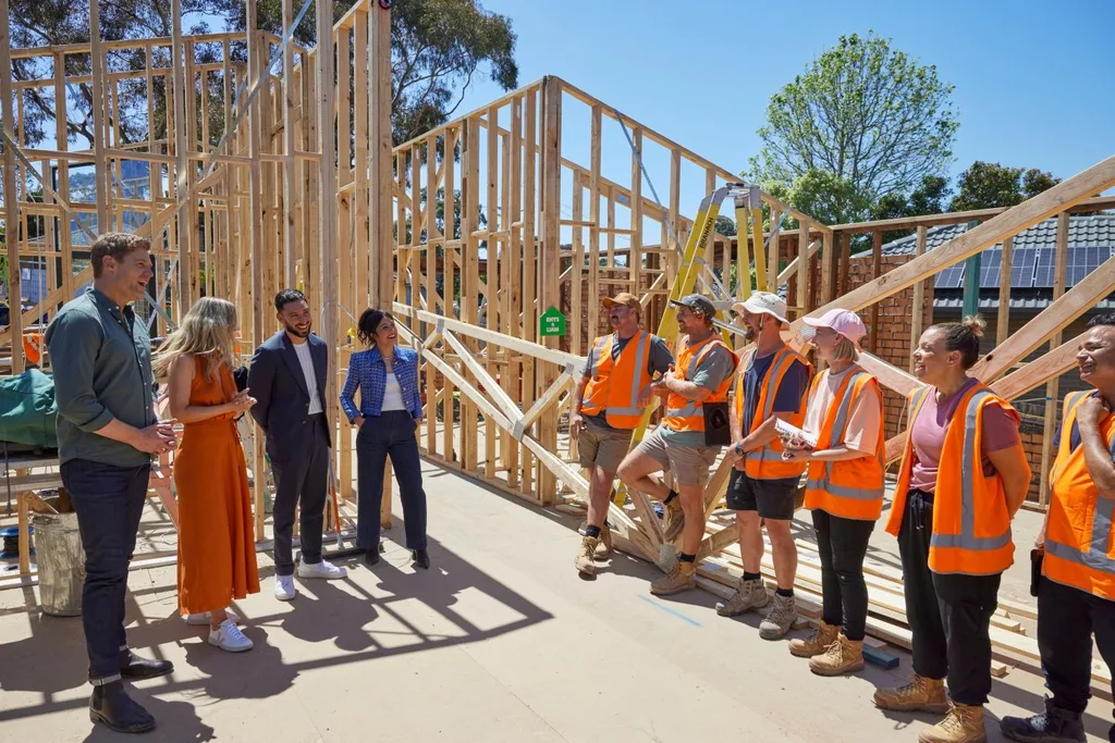 Chris Brown stand on a building site with contestants from Dream Home