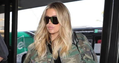 Pregnant Khloé Kardashian Literally Camouflages Her Baby Bump During Trip to the Airport