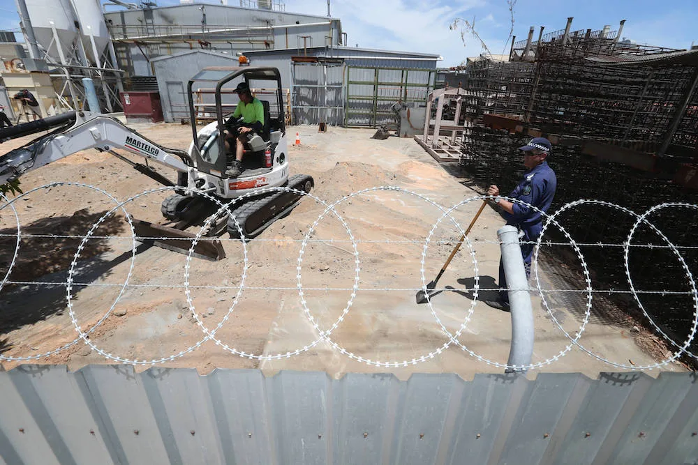 Police excavate the factory site.