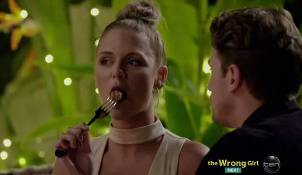 Tara eating a sausage on The Bachelor