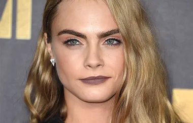 Cara Delevingne Hops on the lip ring trend at London Fashion Week