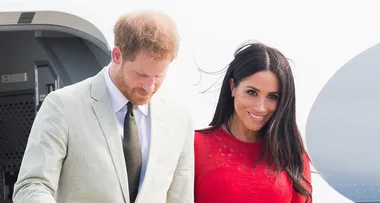 Meghan beams in a red dress in Tonga