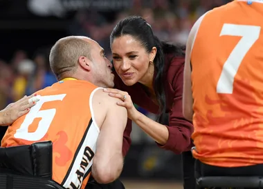 Meghan Markle has the cutest reaction when a basketball player sneaks in a kiss on the cheek