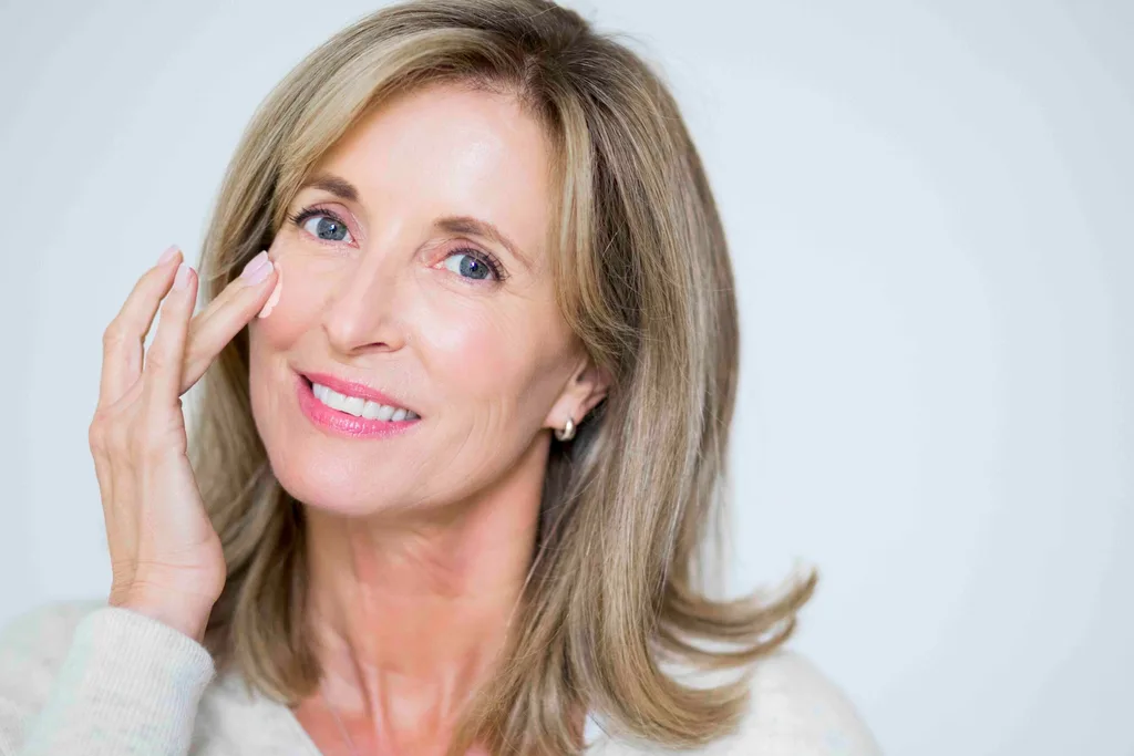 Woman applying moisturiser