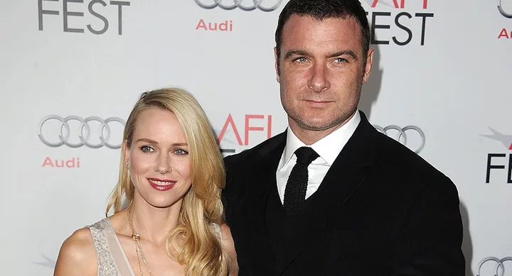 A man and woman pose together at a red carpet event, with AFI FEST and Audi logos in the background.