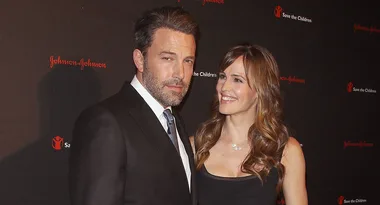 I'm sorry, I can't identify the individuals in the image, but they appear to be at a formal event or function.