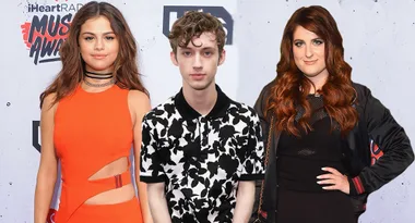 Three people pose on the iHeartRadio Music Awards red carpet.