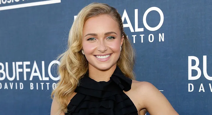 ```plaintext
Person smiling at a Buffalo David Bitton event, wearing a black dress.
```