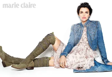 Marie Claire cover: Person sitting, wearing a denim jacket, floral dress, and green knee-high boots on white background.