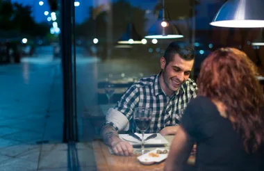 A couple through a window during blue hour