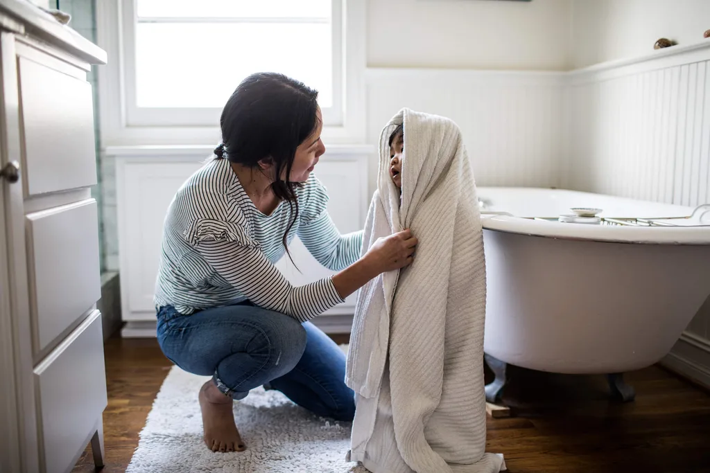 A small child wrapped up in a towel