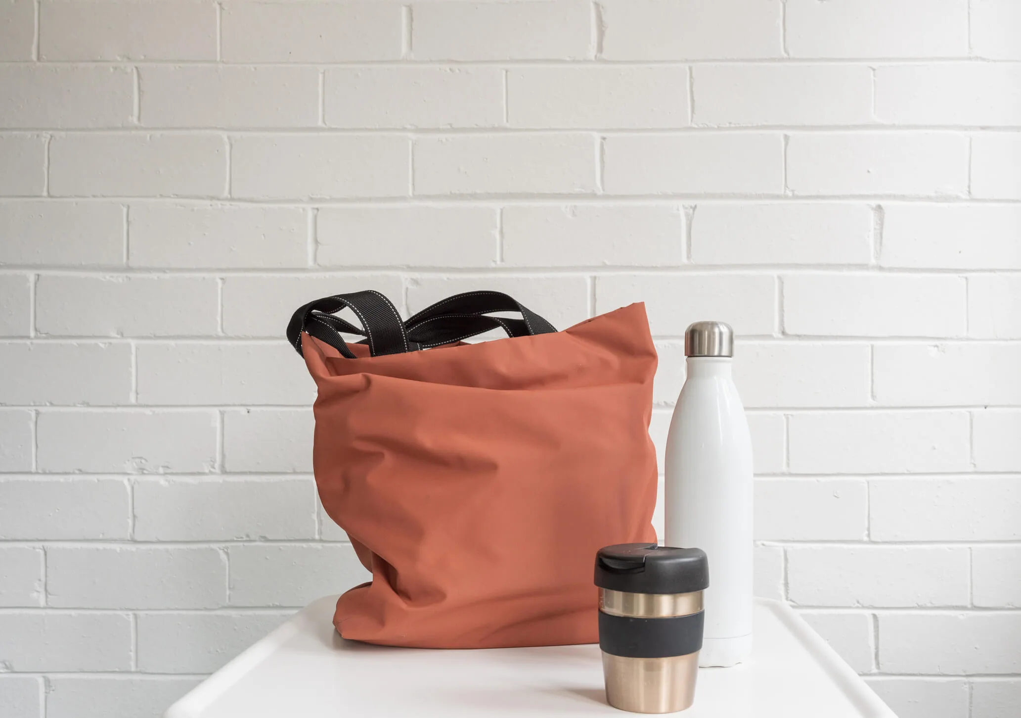 Reusable coffee mug on bench