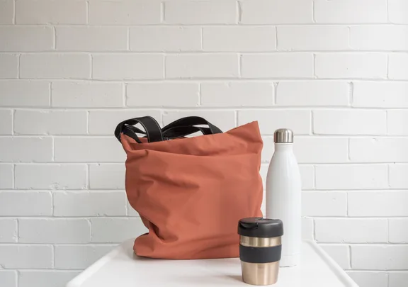 Reusable coffee mug on bench