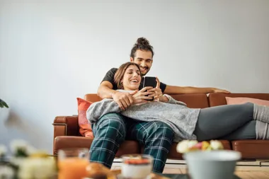 A couple sitting on the couch together