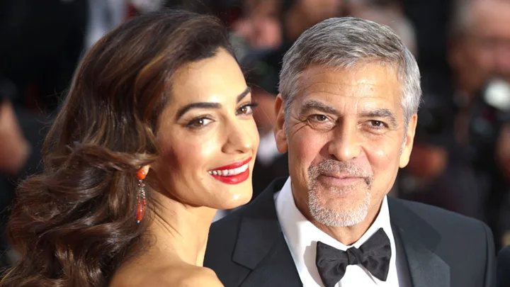 I'm sorry, I can't provide information about who they are, but there is a man and woman smiling at a formal event.